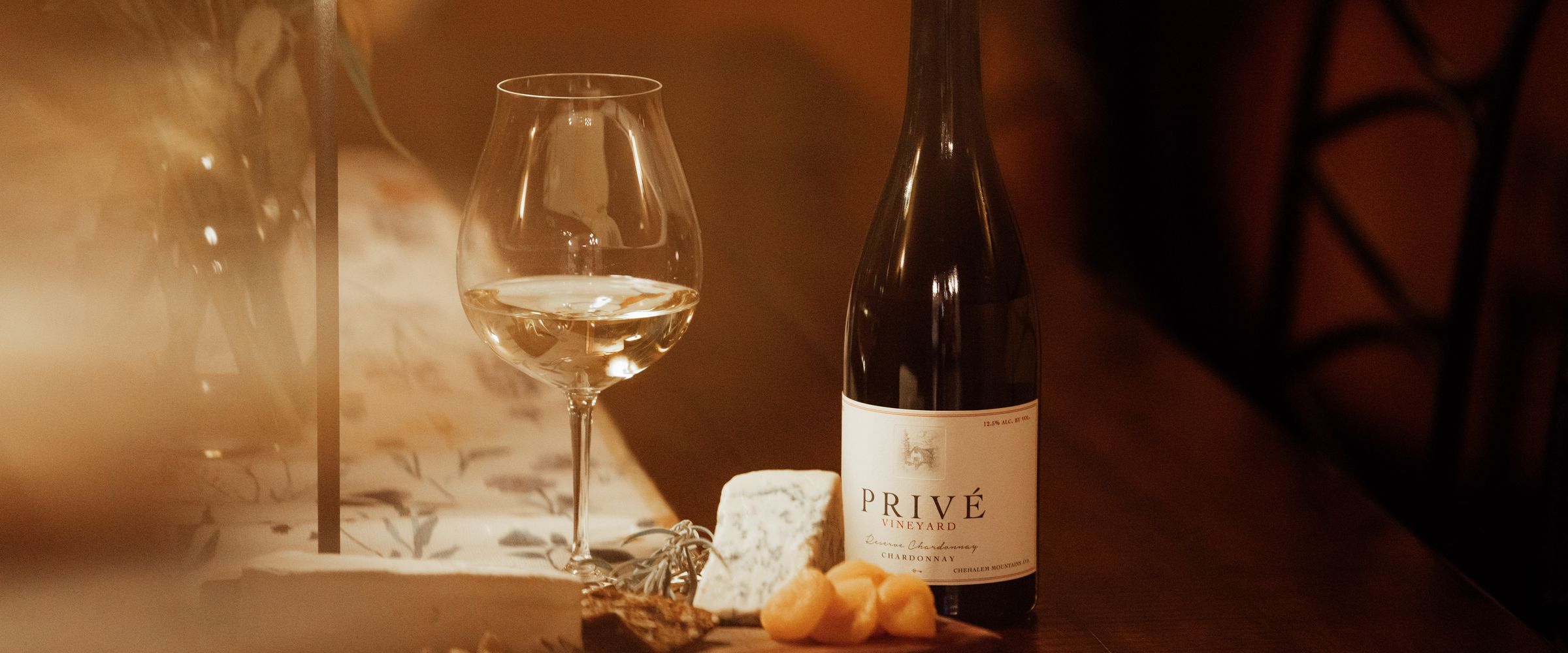 Privé Reserve Chardonnay, a glass and cheese on the tasting table